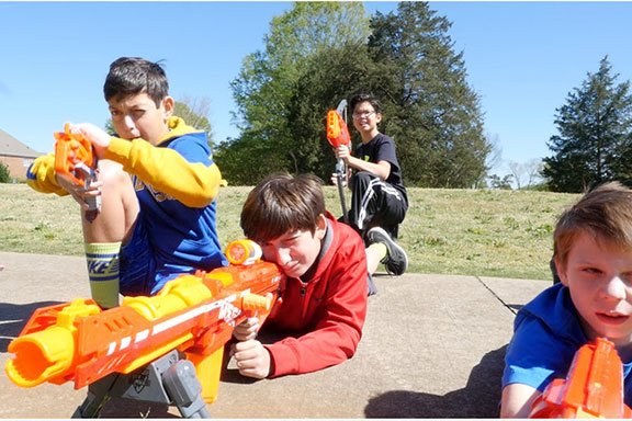 A kid enjoying laser tag on the weekend